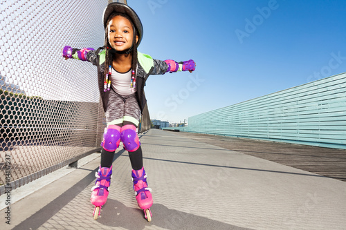 Girl in roller blades doing tricks at skate park