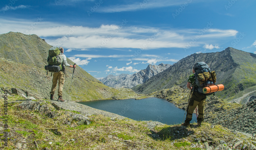Men hiking in mountains. Siberia.