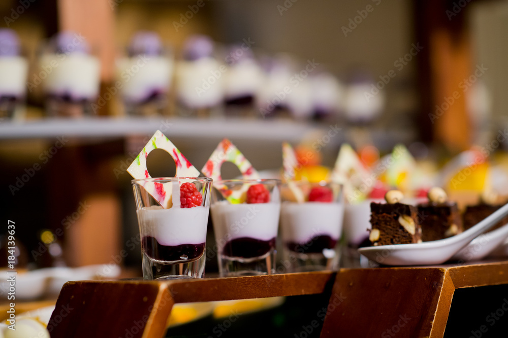 Glass shots  pastry. wedding catering food. mini canapes food.  tasty dessert. Beautiful decorate catering banquet table.  snacks and appetizers. wedding celebration