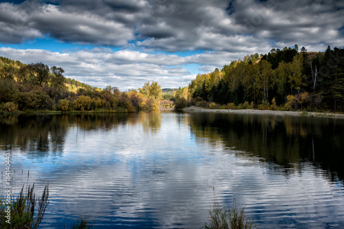 Fototapeta Naklejka Na Ścianę i Meble -  A picturesque river and a textured sky in autumn