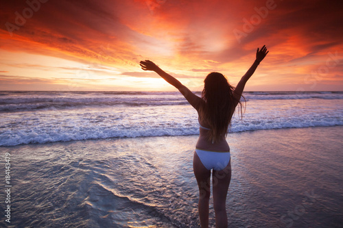 Woman on beach at sunset