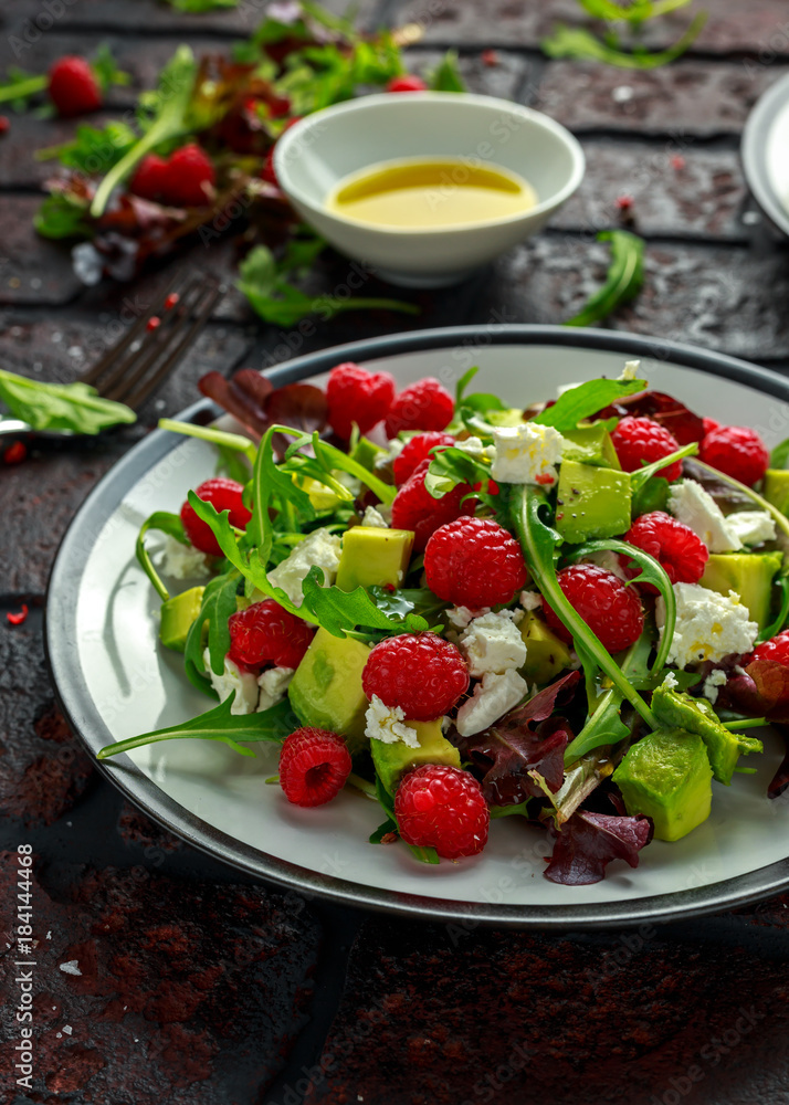 Fresh Tasty Raspberry salad with avocado, green vegetables, nuts, feta cheese, olive oil and herbs. healthy food. Fresh Tasty Raspberry salad with avocado, green vegetables, nuts, feta cheese, olive oil and herbs. healthy food.
