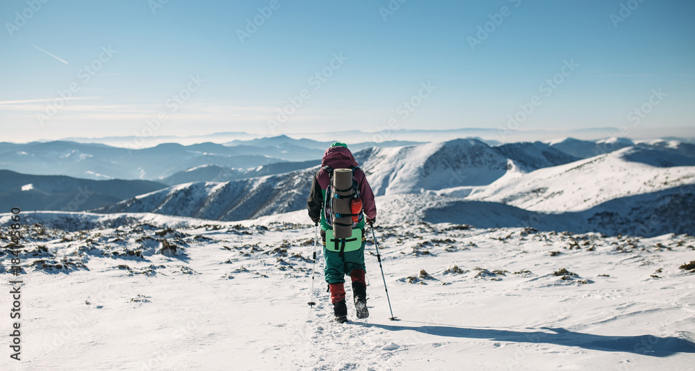 climber walking downhill in winter