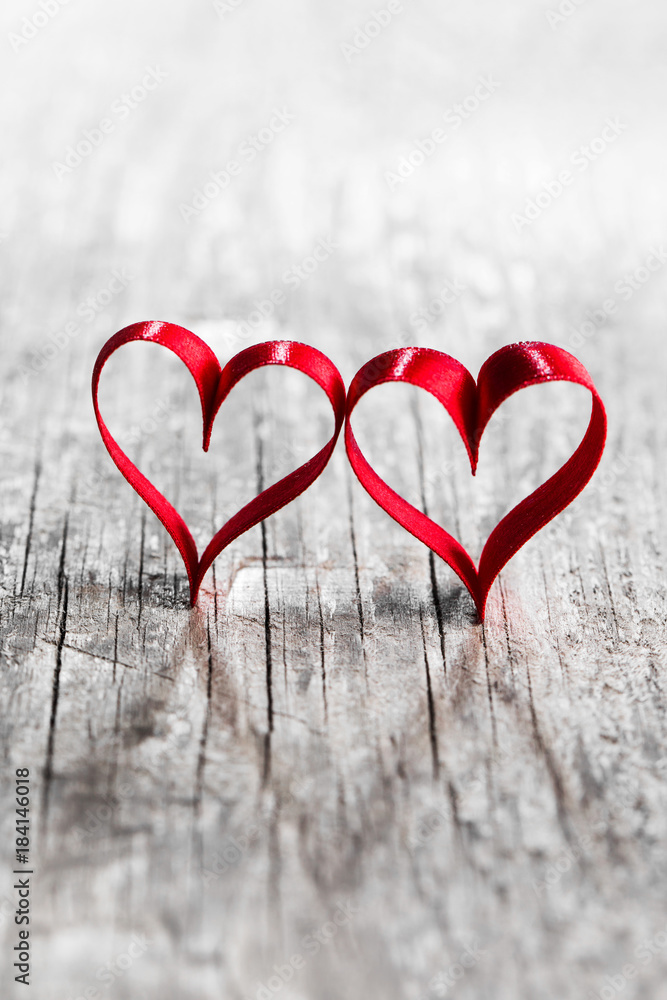 Fototapeta premium Two ribbon hearts on wood