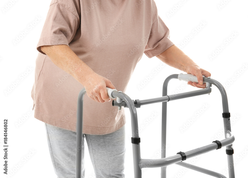 Elderly woman with walking frame on white background