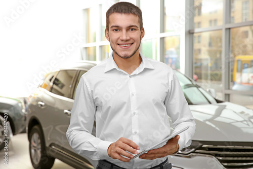 Handsome car salesman with ...