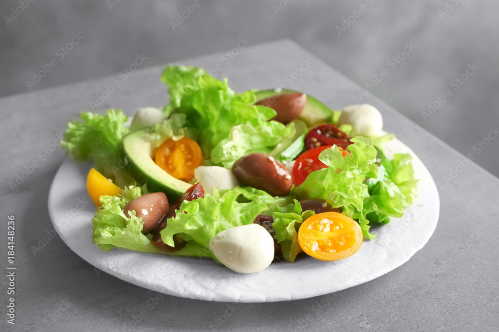 Plate with delicious vegetable salad on table Plate with delicious vegetable salad on table