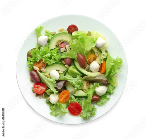 Plate with delicious vegetable salad on white background, top view