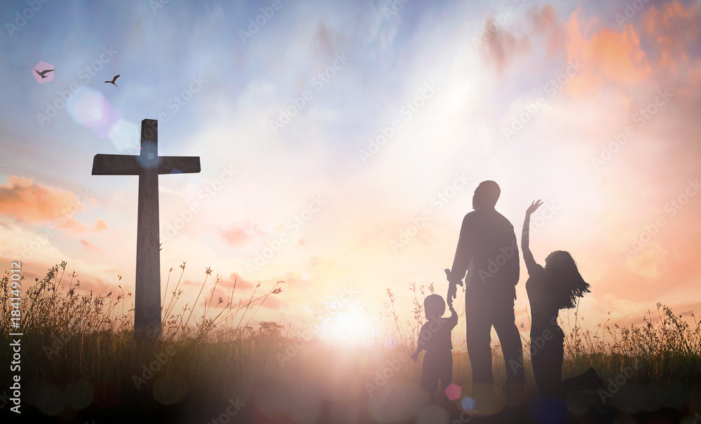 Family worship concept: Silhouette father mother and son looking for the cross on autumn sunrise background. - obrazy, fototapety, plakaty 