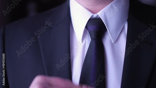 Businessmann corrects his necktie