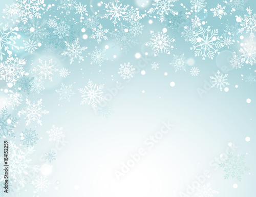 Winter holidays snowy background. Falling snowflakes on blue sky. Abstract corner frame composition. Magical Christmas backdrop. New Year greeting card template with copyspace.