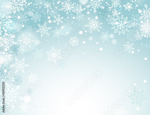 Winter holidays snowy background. Falling snowflakes on blue sky. Abstract corner frame composition. Magical Christmas backdrop. New Year greeting card template with copyspace.