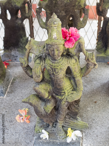 Bild auf Leinwand Statue of deity Shani, lord of the Saturn, with a raised hand giving blessing and with one foot resting on the crow, his servant