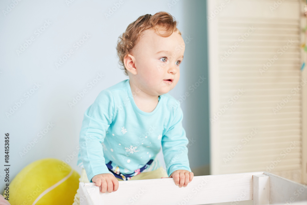 little child is playing with toys in the studio little child is playing with toys in the studio