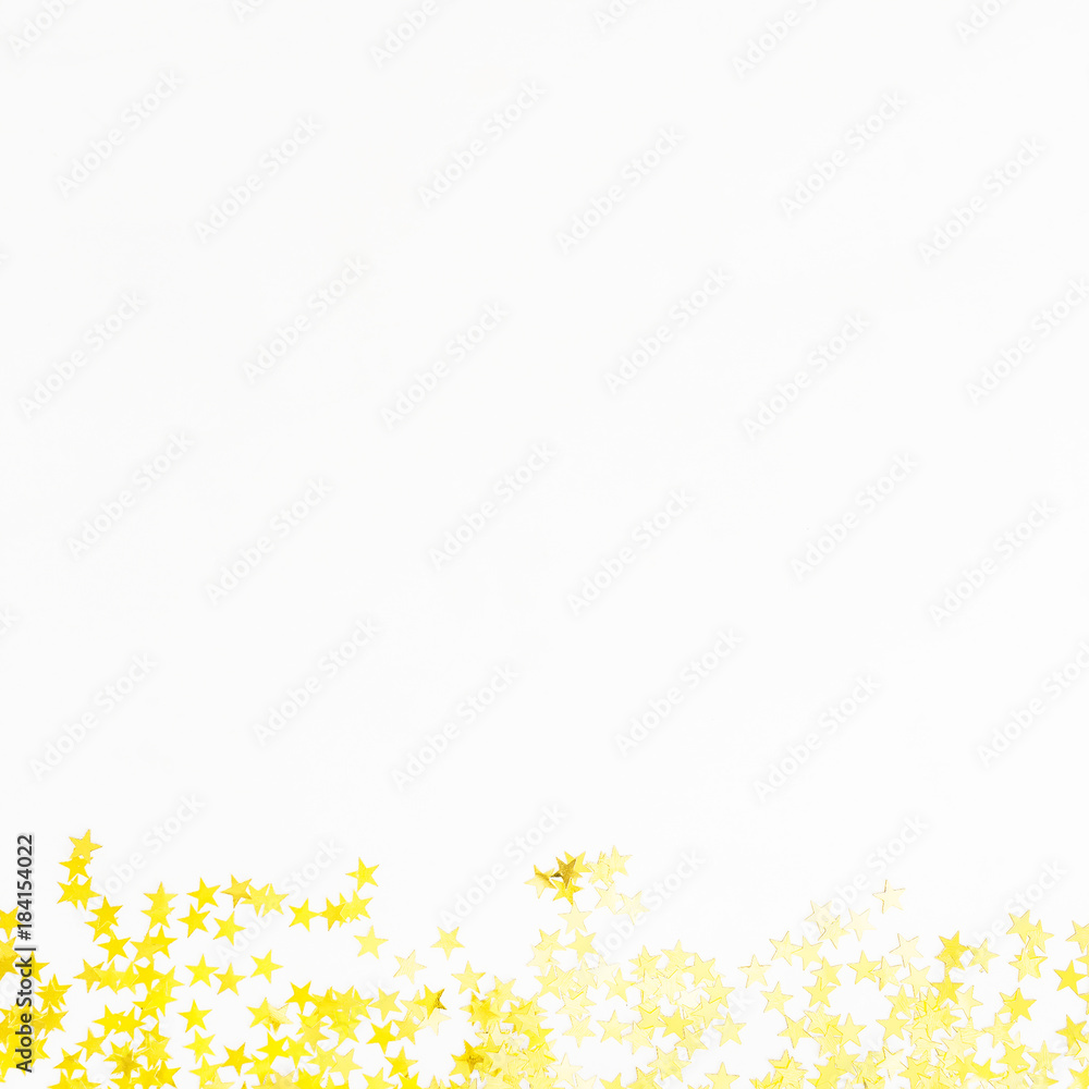 Golden confetti isolated on white background. Flat lay, top view. Copy space Golden confetti isolated on white background. Flat lay, top view. Copy space