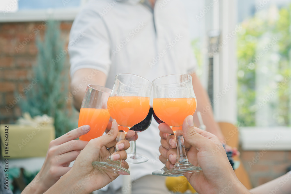 Group young people having drink and fun in santa hats throwing colorful on celebrating new year or christmas party, exchanging presents Group young people having drink and fun in santa hats throwing colorful on celebrating new year or christmas party, exchanging presents