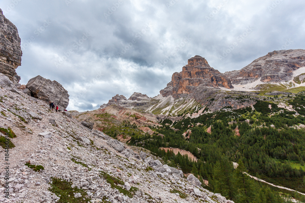 Trekkers on path in the upper part of  Travenanzes Valley Dolomites, Italy
