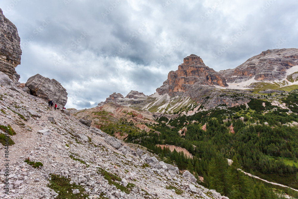 Fototapeta premium Trekkers on path in the upper part of Travenanzes Valley Dolomites, Italy