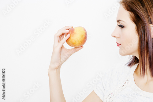 Wallpaper Mural the girl holds the peach. Young woman holds peach in her hands. Torontodigital.ca