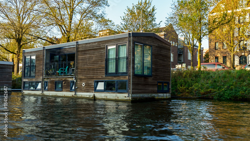 Traditional Floating boat house in Amsterdam canals, the Netherlands, October 13, 2017 photo