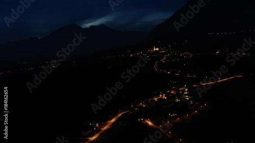 aerial night view of mountain village, mountains background
