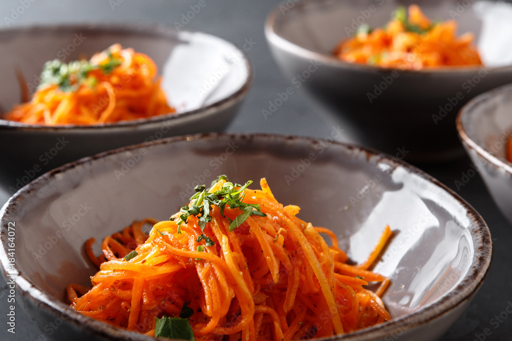 Set of plates with russian korean salad, closeup Set of plates with russian korean salad, closeup