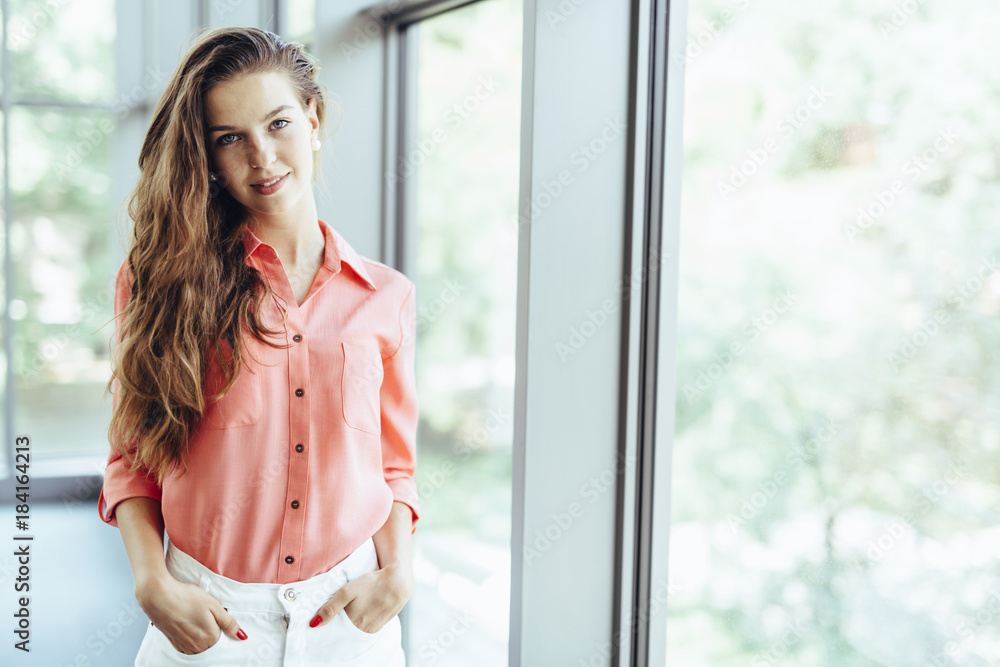 Beautiful businesswoman with hands in pockets Beautiful businesswoman with hands in pockets