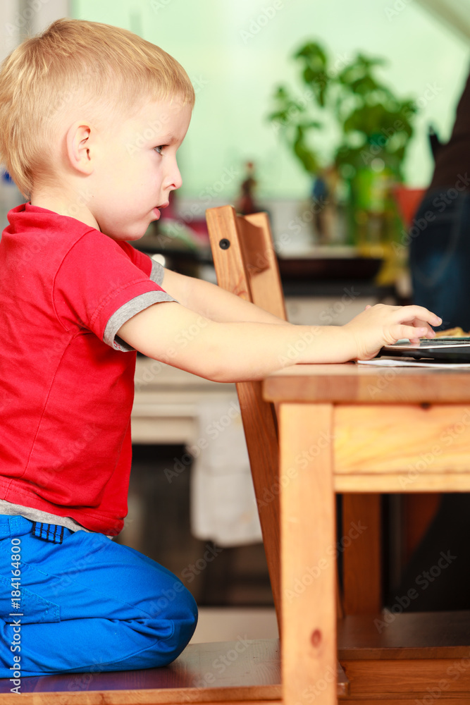 Little boy using laptop computer playing games Little boy using laptop computer playing games