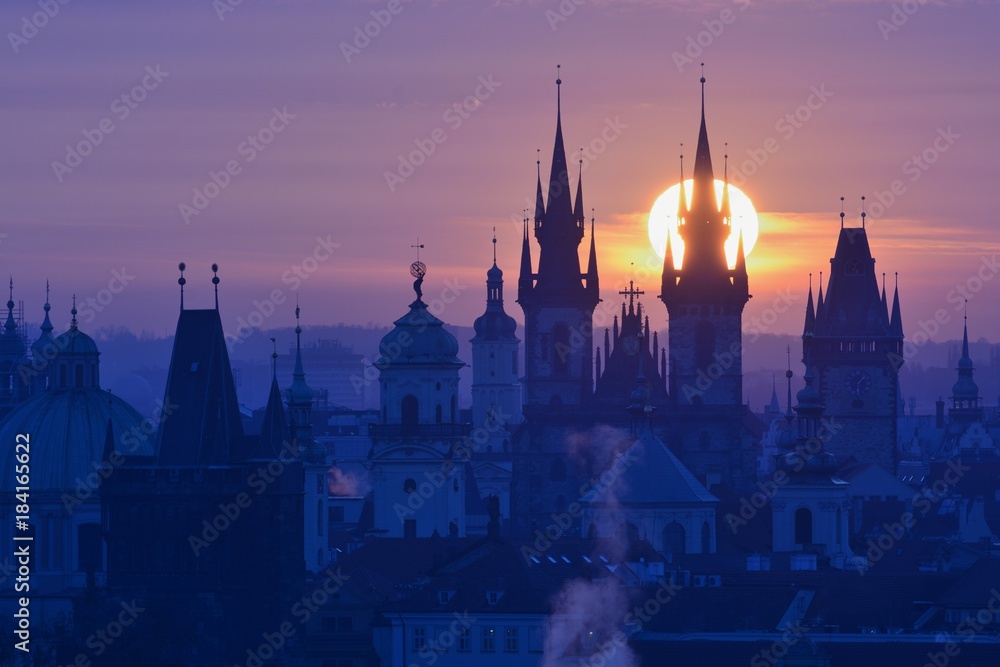 Sun disk behind spire of the Prague Church of Our Lady before Tyn