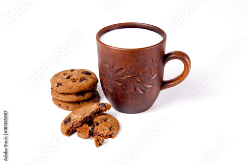 Cup of milk with biscuits on white background.
