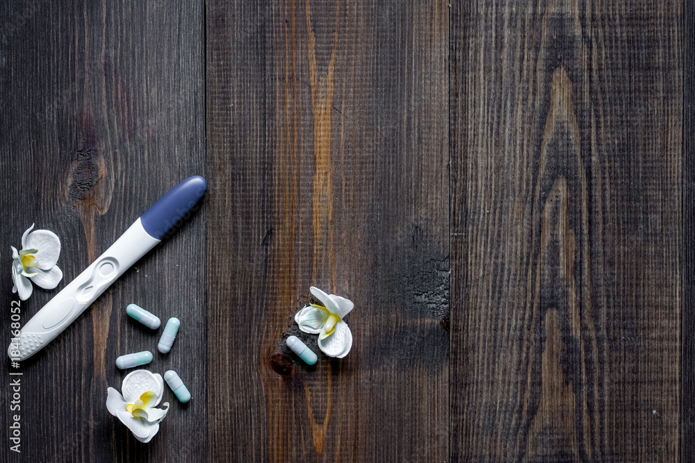Pregnancy test and contraceptive pills on wooden background top Pregnancy test and contraceptive pills on wooden background top