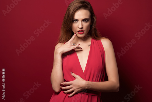 beauty girl with red dress in red background