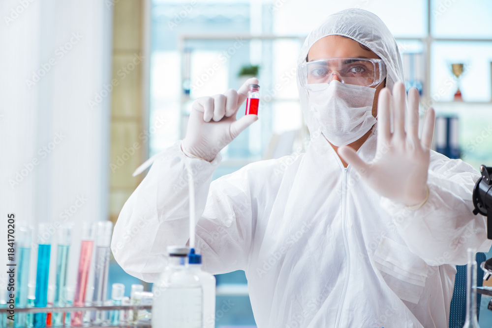 Chemist working in the laboratory with hazardous chemicals Chemist working in the laboratory with hazardous chemicals