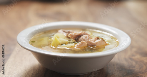 closeup fish soup with salmon on wood table