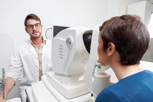 Fototapeta Naklejka Na Ścianę i Meble -  eye Doctor is measuring a patient's visual field with the OCT test /Ophthalmologist in eyes clinic is doing diagnostic vision exam/ concept health and eyes care