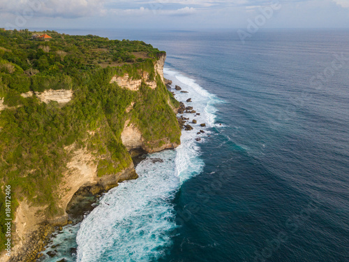 Aerial view of ocean rocky cliff near Uluwatu temple. Scenic landscape of fantastic view from drone. Bali, Indonesia.