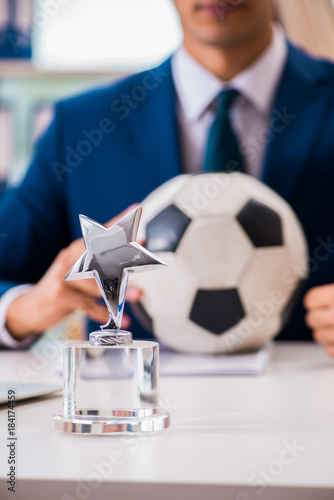 Businessman playing football in the office © Elnur