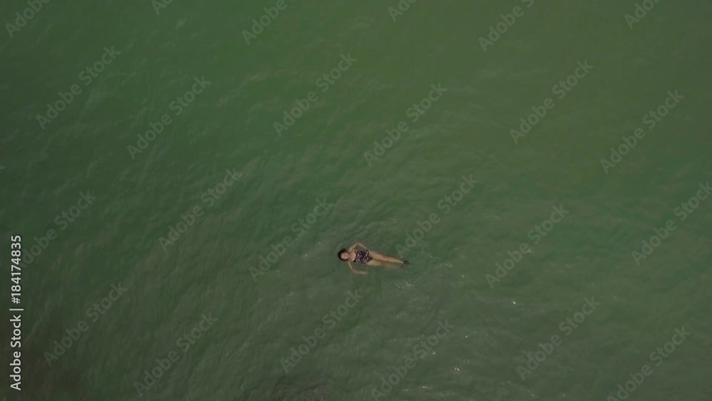 aerial shot woman swimming alone in the sea aerial shot woman swimming alone in the sea