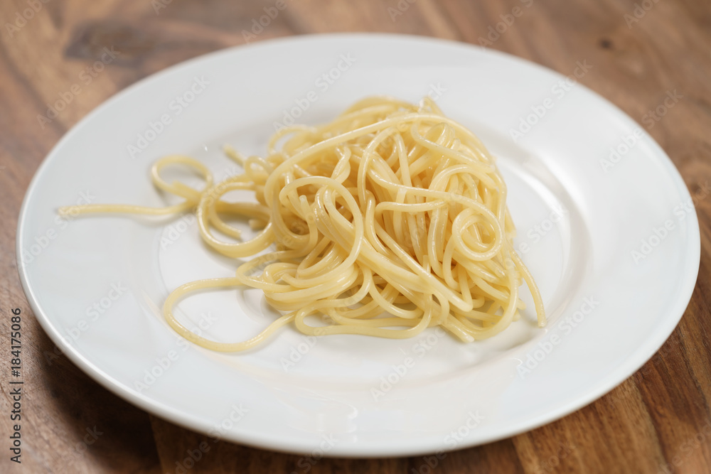 spaghetti on white plate on table