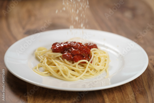 add grated parmesan on spaghetti bolognese