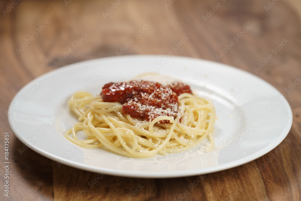 spaghetti bolognese on white plate on wood table spaghetti bolognese on white plate on wood table