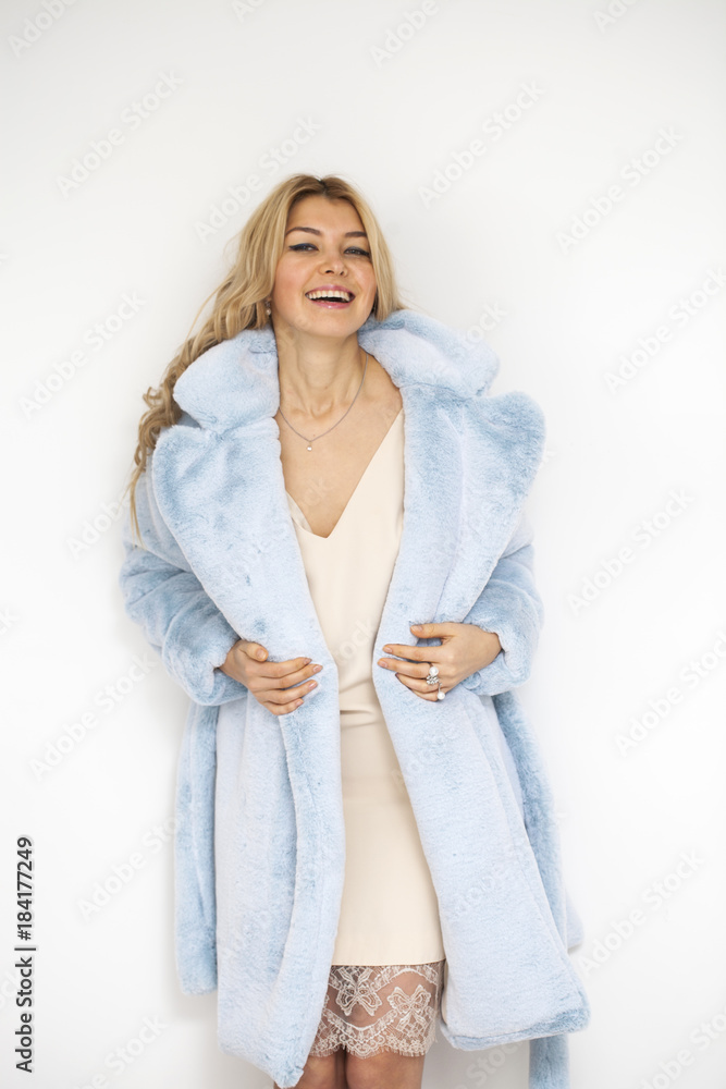 Young beautiful blonde woman in a blue fur coat Young beautiful blonde woman in a blue fur coat