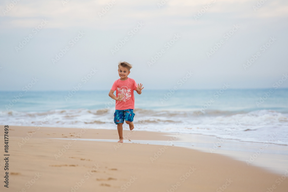 boy has fun at the seashore in summertime