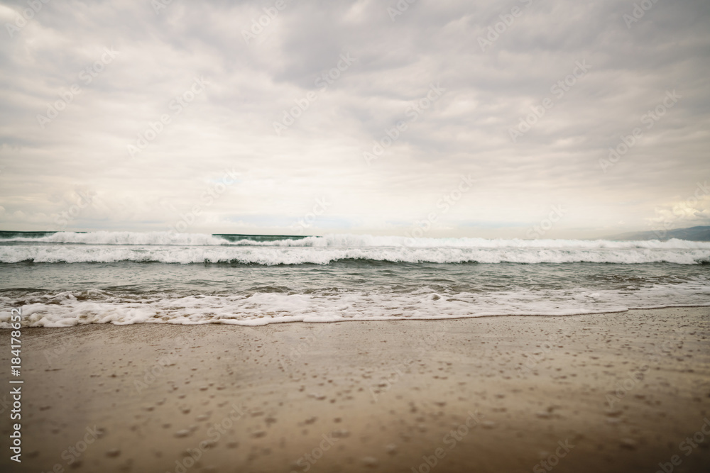 ocean waves on Santa Monica beach in cloudy november day