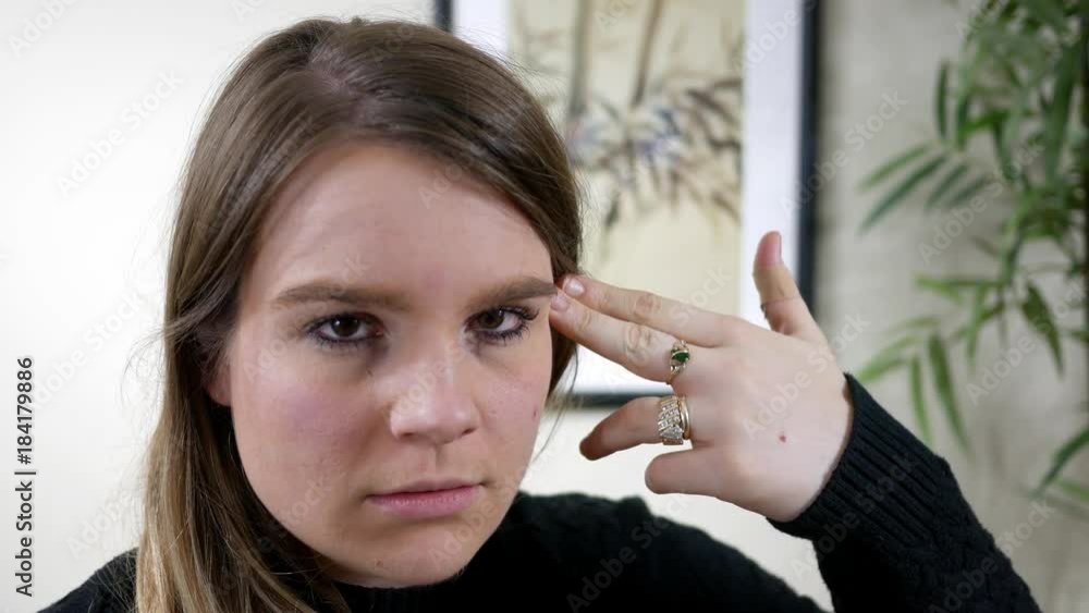 Beautiful Brunette woman shoots herself with finger gun ALT Beautiful Brunette woman shoots herself with finger gun ALT