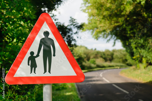 Triangular sign warning drivers of the presence of pedestrians on a narrow rural road