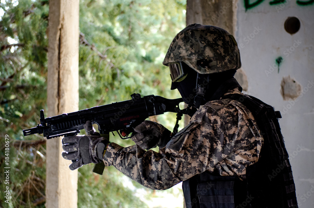 Fototapeta premium Trops wear digital uniform protection mask helmet rifle and vest