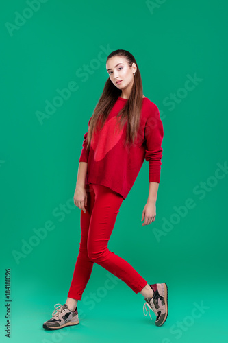 woman in red sweater on green background