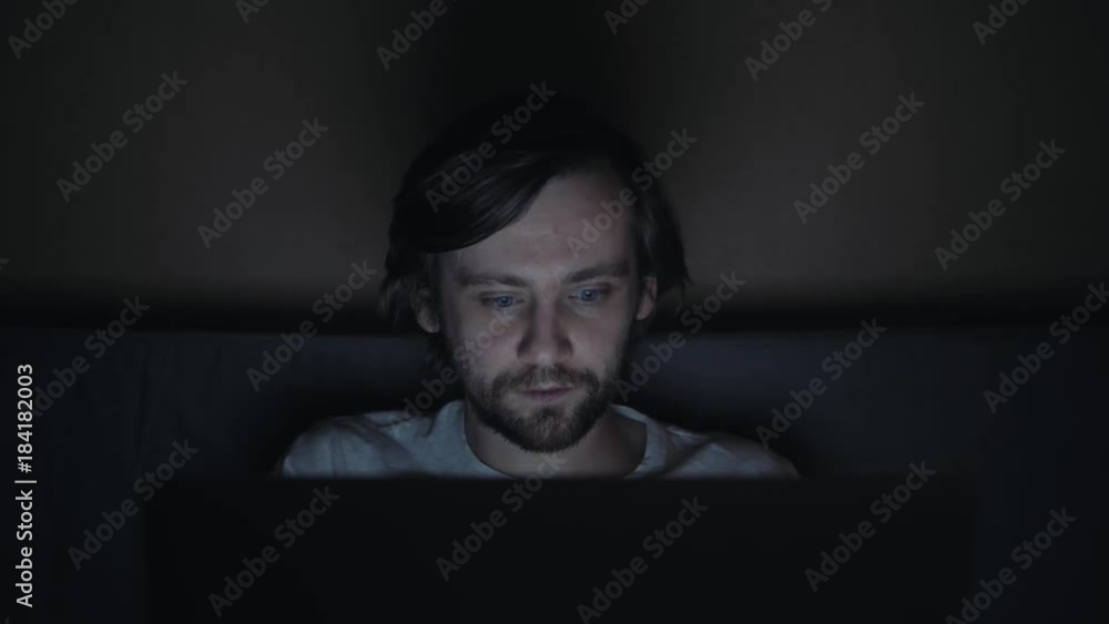 Businessman working on laptop at home on sofa until late. Man trade bitcoin crypto currencies, trader work at night growth Businessman working on laptop at home on sofa until late. Man trade bitcoin crypto currencies, trader work at night growth