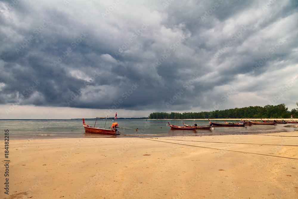 Boats in the tropical sea under gloomy dramatic sky Boats in the tropical sea under gloomy dramatic sky